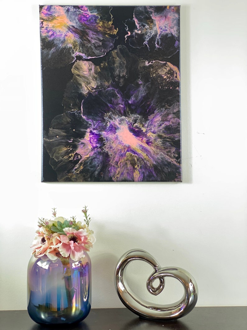 May include: Abstract painting on canvas with purple, pink, gold, and black colors. The painting features a swirling, fluid design that resembles flowers.