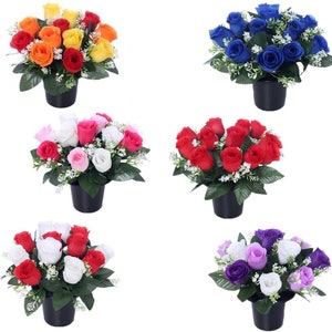 May include: Assortment of artificial flower arrangements in pots. Each arrangement features a cluster of silk roses in a different colour, including orange, blue, pink, red, white, and purple. The roses are surrounded by small white flowers and green leaves.