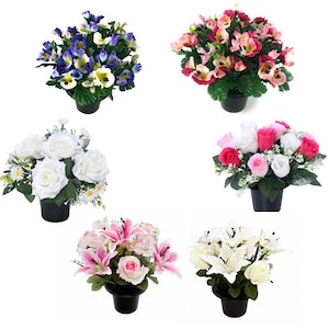May include: Six arrangements of artificial flowers in black pots. The collection includes pansies in purple and yellow, pink and yellow blossoms, white roses with daisies, mixed pink and white roses, pink lilies with roses, and white lilies with roses.