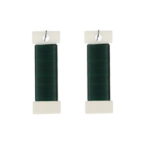 May include: Two spools of green floral wire, each wrapped in white plastic and secured with a metal hook.