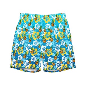 May include: Blue swim trunks with a repeating pattern of pineapples wearing sunglasses and yellow and white flowers. The trunks have an elastic waistband and are made of a lightweight material.