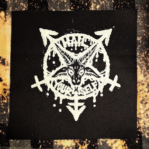 May include: Black and white embroidered patch with a pentagram and a goat's head in the center. The text "Harm Yourself" is written around the goat's head.