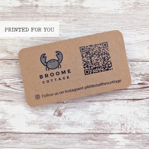 May include: A rectangular kraft paper business card with rounded corners. The card features a crab logo, the text "BROOME COTTAGE", a QR code, and the Instagram handle @littlestaitescottage. The words "PRINTED FOR YOU" are at the top.