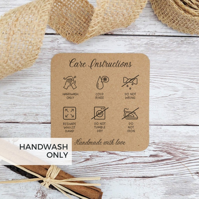May include: A brown card with care instructions for a handmade item. The card has six icons with instructions for handwashing, cold rinsing, not wringing, reshaping while damp, not tumble drying, and not ironing. The card also says "Handmade with love" and "Handwash Only".
