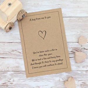 May include: A brown card with a heart and the text "A hug from me to you" and "You've been such a star in class this year. We've had a fun and busy time. And though it's time to say goodbye I know you will continue to shine!"