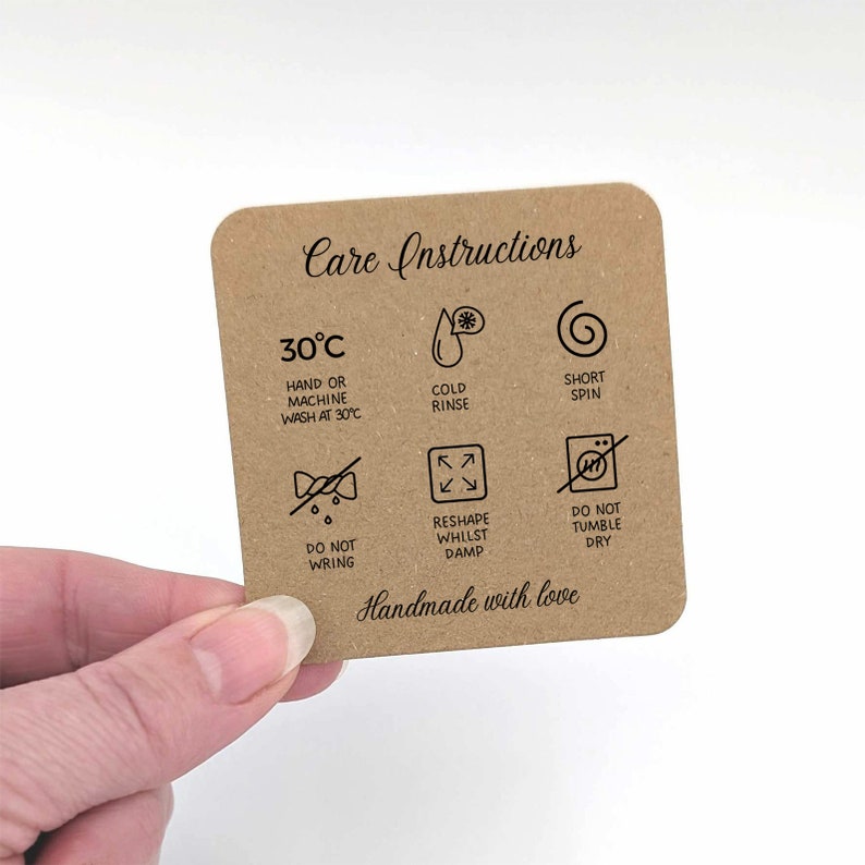 May include: Care instructions for a garment. The instructions include washing at 30 degrees Celsius, cold rinse, short spin, do not wring, reshape whilst damp, and do not tumble dry. The text "Handmade with love" is at the bottom of the card.