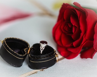 Sterling silver and garnet ring supplied in antique-style heart-shaped leather ring box