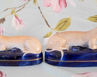 Fine 19th century Staffordshire quill or pen holders: recumbent greyhounds, gilt lined base