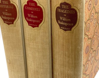 May include: Three vintage books with tan linen covers. The titles are "The Histories", "The Comedies", and "The Tragedies" of William Shakespeare, with gold lettering on burgundy labels. The last book has a patterned cover.