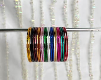 May include: A set of 18 colorful metal bangles, stacked and arranged in a rainbow pattern. The bangles are shiny and have a metallic finish.