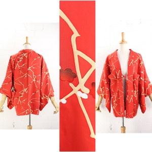 May include: A red Japanese kimono with a gold floral pattern. The kimono has long sleeves and a tie at the waist.