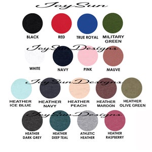 May include: A color chart featuring 16 different fabric colors, including black, red, navy, pink, and various heather shades. The text "Joy Sun Designs" is displayed in a cursive font above the color swatches.