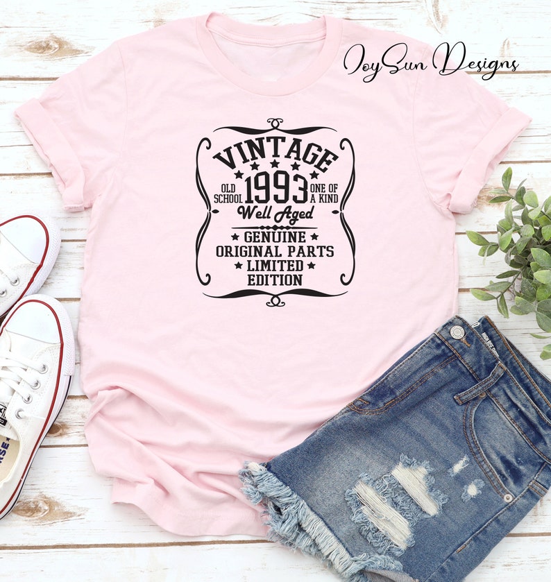 May include: Pink t-shirt with a black vintage style graphic that says "Vintage 1993 Old School Well Aged One of a Kind * Genuine * Original Parts * Limited * Edition"