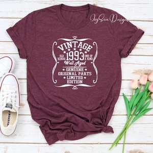 May include: A maroon t-shirt with a white vintage design that says "Vintage 1993 Old School One of a Kind Well Aged Genuine Original Parts Limited Edition".