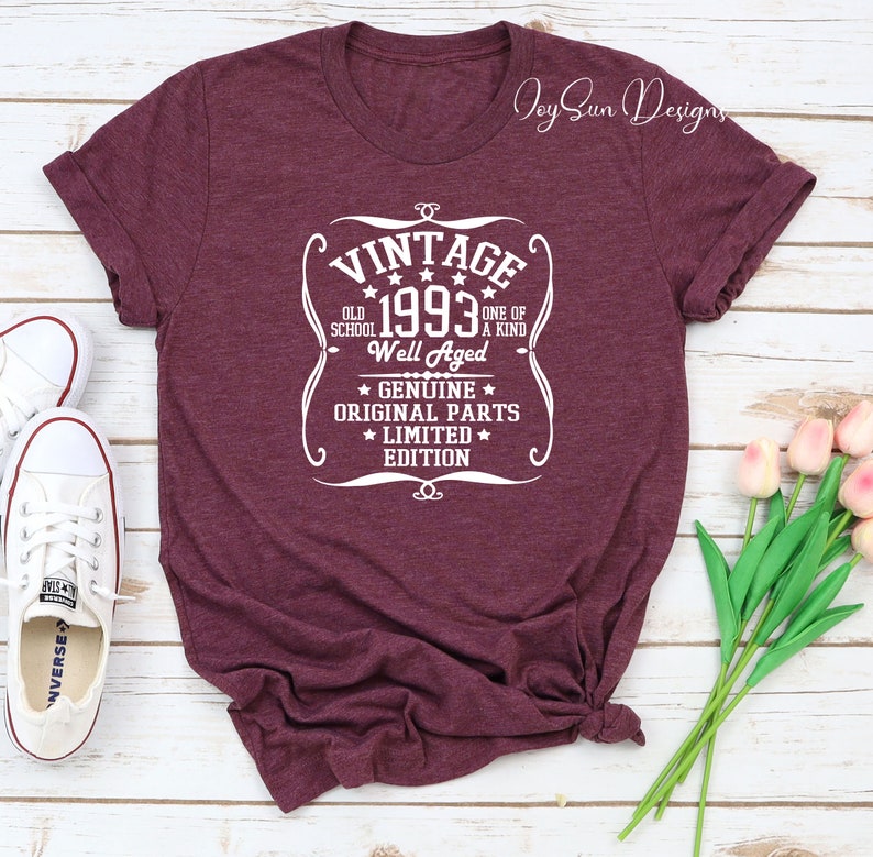 May include: A maroon t-shirt with a white vintage design that says "Vintage 1993 Old School One of a Kind Well Aged Genuine Original Parts Limited Edition".
