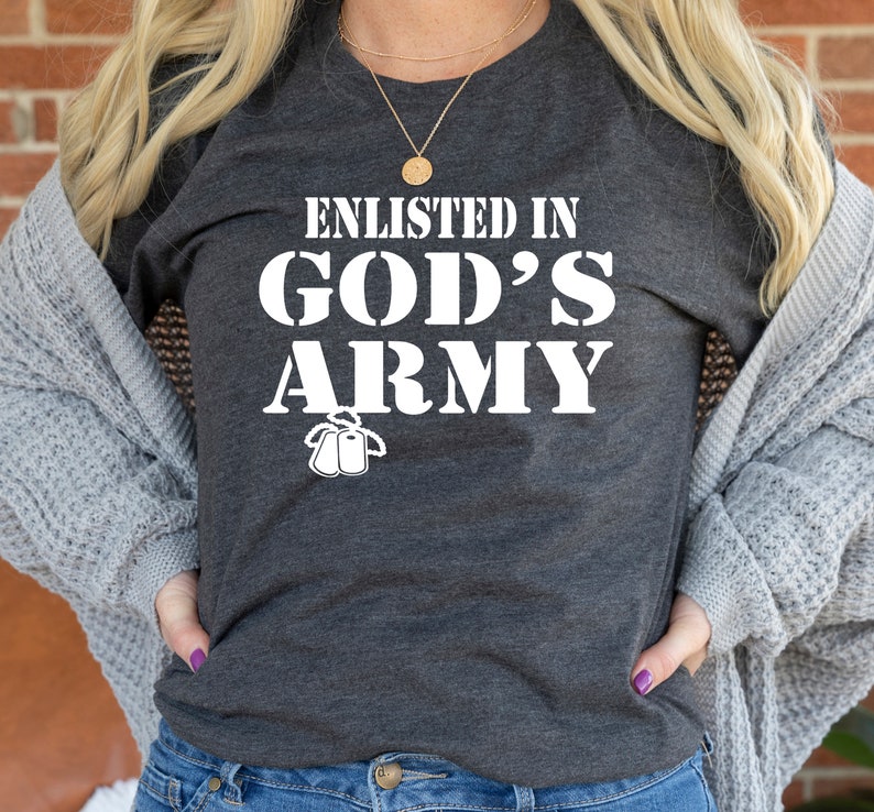May include: A gray t-shirt with the text "Enlisted in God's Army" in white lettering. The shirt also features a small graphic of two dog tags.