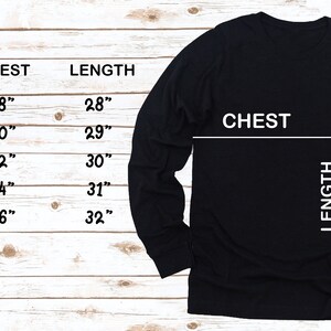 May include: Size chart for a long-sleeved shirt with measurements in inches for chest and length. Sizes include S, M, L, XL, and 2XL.