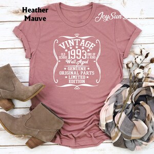 May include: Heather mauve t-shirt with a white vintage design that says "Vintage 1993 Old School One of a Kind Well Aged Genuine Original Parts Limited Edition".