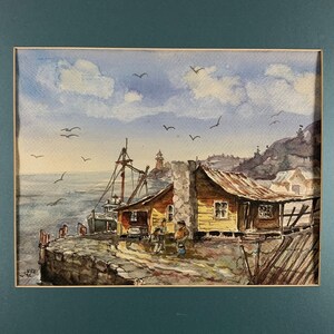 May include: Watercolor painting of a small yellow house with a red roof, a boat, and a lighthouse in the background. The scene is set on a rocky shore with a blue sky and white clouds.