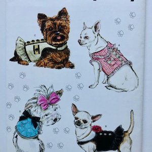 May include: Simplicity sewing pattern S9970 featuring illustrations of four small dogs wearing various outfits. The pattern includes sizes XXS-M. The dogs are shown wearing dresses, vests, and bows. The text "Designed and printed in USA" is also visible.