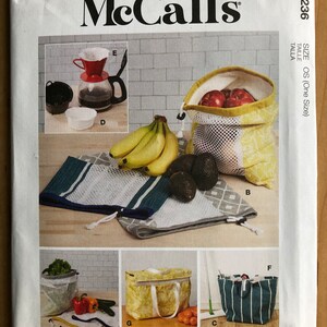 May include: A sewing pattern for making reusable grocery bags. The pattern includes instructions for making a variety of bags, including a tote bag, a mesh bag, and a drawstring bag. The pattern is from McCall's and is size OS (One Size).