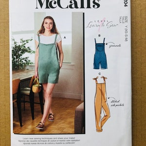 May include: A sewing pattern for overalls with three different styles. The pattern is for sizes XS, S, and M. The pattern is called "Learn to Sew" and is designed and printed in the USA.