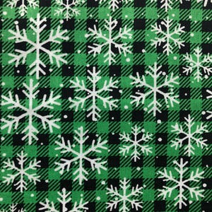 May include: A fabric with a green and black plaid pattern, overlaid with white snowflakes. The snowflakes vary in size and are evenly distributed across the fabric. The design is suitable for winter or holiday-themed projects.
