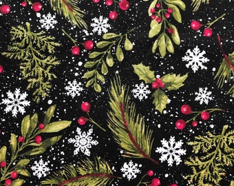 May include: A black fabric with a repeating pattern of green leaves, red berries, and white snowflakes. The pattern is reminiscent of a winter holiday theme.