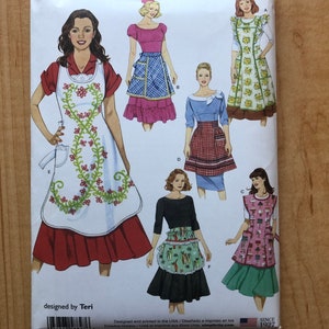 May include: Simplicity sewing pattern number 8827 for aprons. The pattern includes five different apron styles, with a variety of colors and patterns. The pattern is designed by Teri.