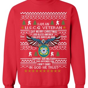 May include: Red sweatshirt with a festive design. Features text: "I AM AN U.S.C.G VETERAN" and "I SAY MERRY CHRISTMAS." Includes an eagle with the American flag and the Coast Guard emblem. The phrase "IN GOD WE TRUST" is also present.