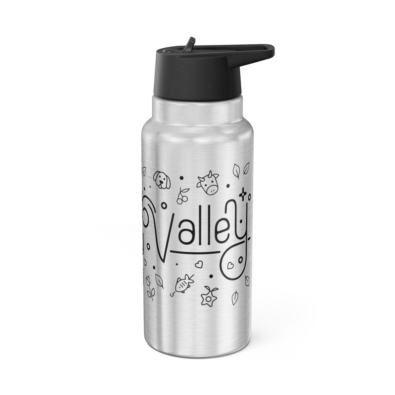 May include: A silver water bottle with a black lid and a spout. The bottle has a black and white design with the word "Valley" and various farm animal illustrations.