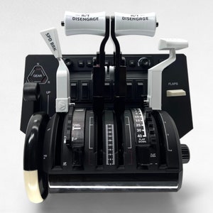 May include: A black flight simulator panel with white control levers and knobs. The panel has labels for "SPD BRK", "GEAR", "FLAPS", and "A/T DISENGAGE".