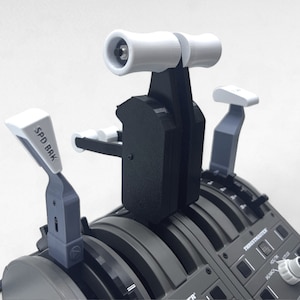 May include: A black and gray flight simulator control panel with multiple levers and switches. The panel features a throttle quadrant, a speed brake lever labeled "SPD BRK", and a trim wheel.