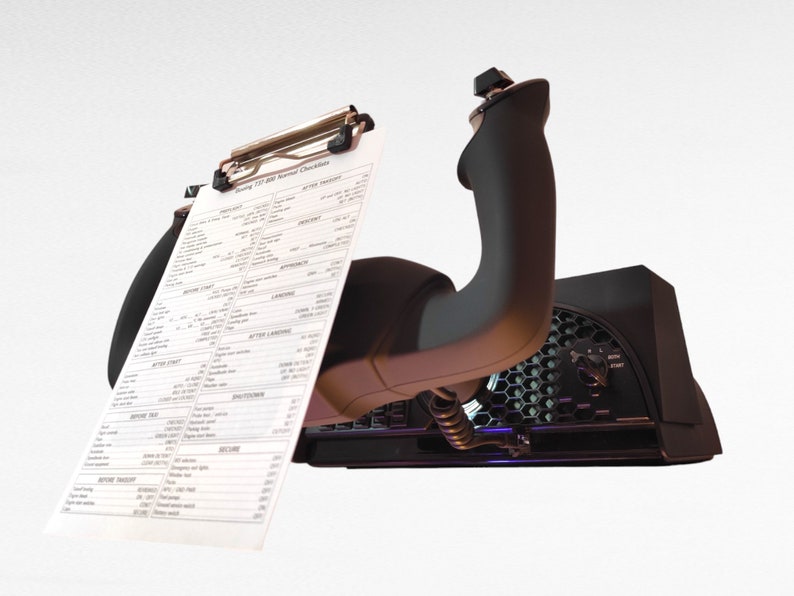 May include: A black flight simulator joystick with a checklist attached to the top. The checklist is titled "Boeing 737  Normal Checklists".