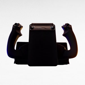 May include: A black flight simulator joystick with two black handles. The handles have a textured grip and are angled slightly outward. The base of the joystick is black and has a silver metal plate with two screws.