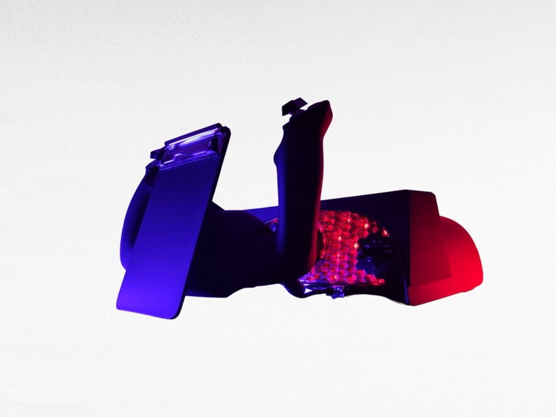 May include: A black and red gaming chair with a blue and purple light. The chair has a headrest and a lumbar support.