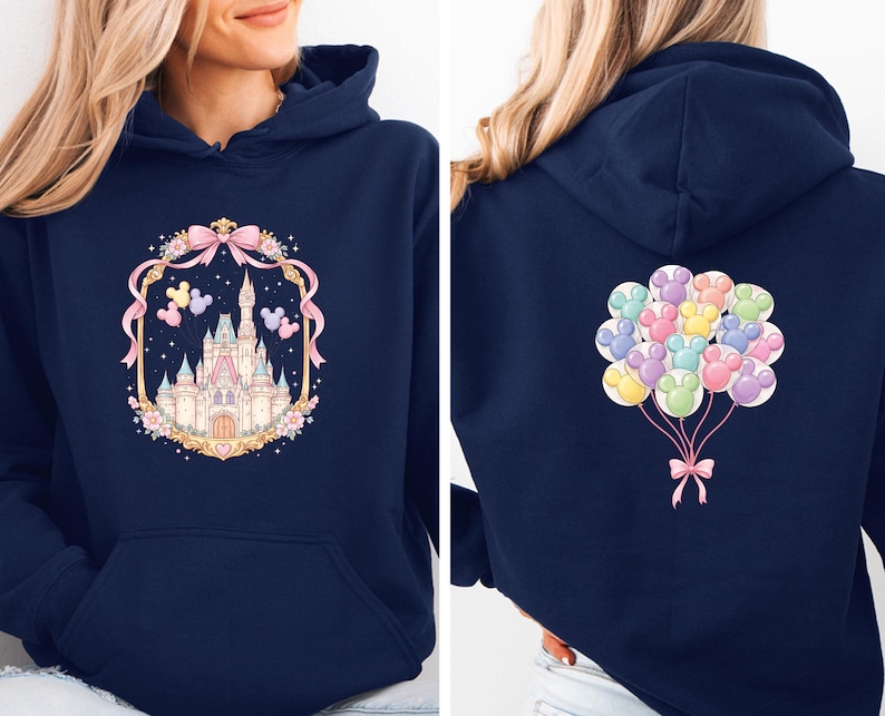 May include: Navy blue hoodie featuring a castle design on the front, framed by a pink bow and floral elements. The back of the hoodie displays a cluster of colorful paw print balloons tied with a pink bow. The hoodie has a front pocket and a hood.
