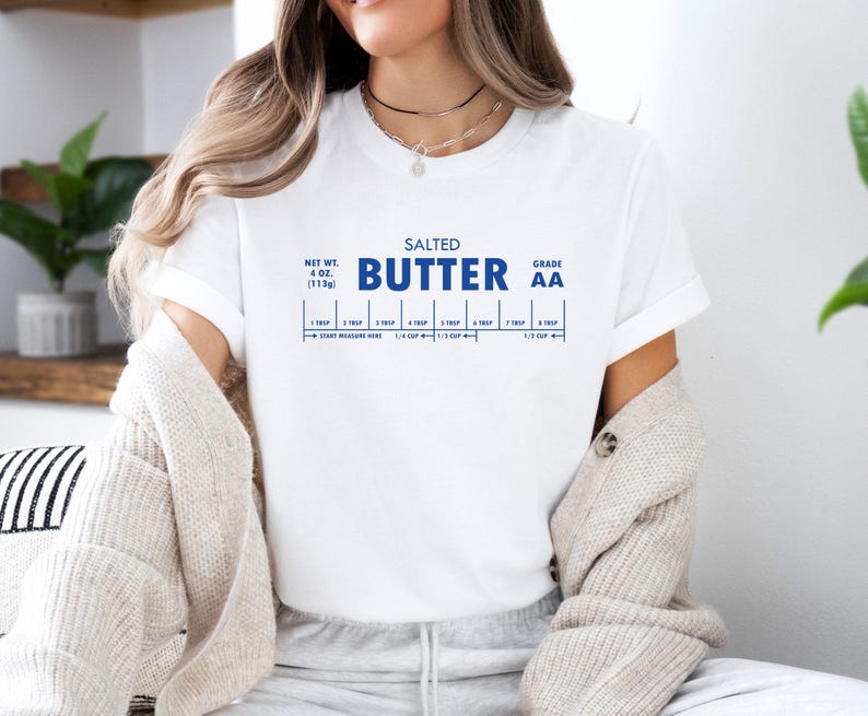 May include: White t-shirt with a blue graphic that reads "SALTED BUTTER GRADE AA" and includes a measurement chart for tablespoons and cups.