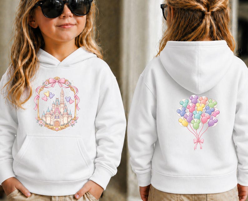 May include: White hooded sweatshirt featuring a colorful castle design on the front and a cluster of Mickey Mouse balloon graphics on the back. The front design includes a pink bow and floral accents. A comfortable and stylish garment for kids.