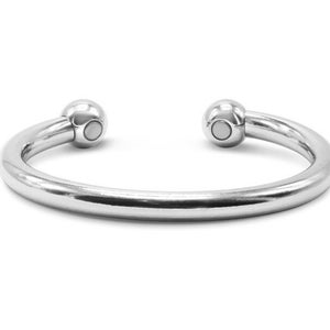 May include: A silver magnetic therapy bracelet with two round magnetic balls on the ends.