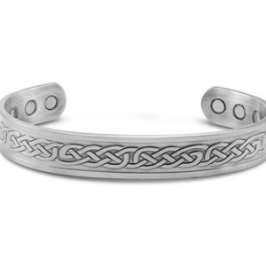 May include: Silver-toned magnetic bracelet with a Celtic knot design. The bracelet has a hinged clasp.