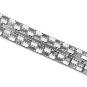 May include: A silver bracelet with a geometric pattern of alternating silver and white squares.