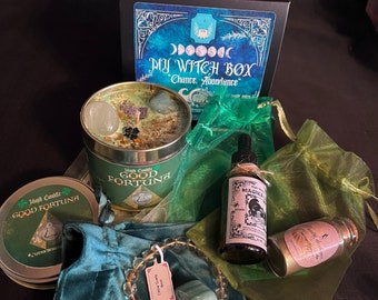 May include: A green and gold witch box containing a candle, oil, and other items. The box is labelled "My Witch Box - Chance, Abundance".