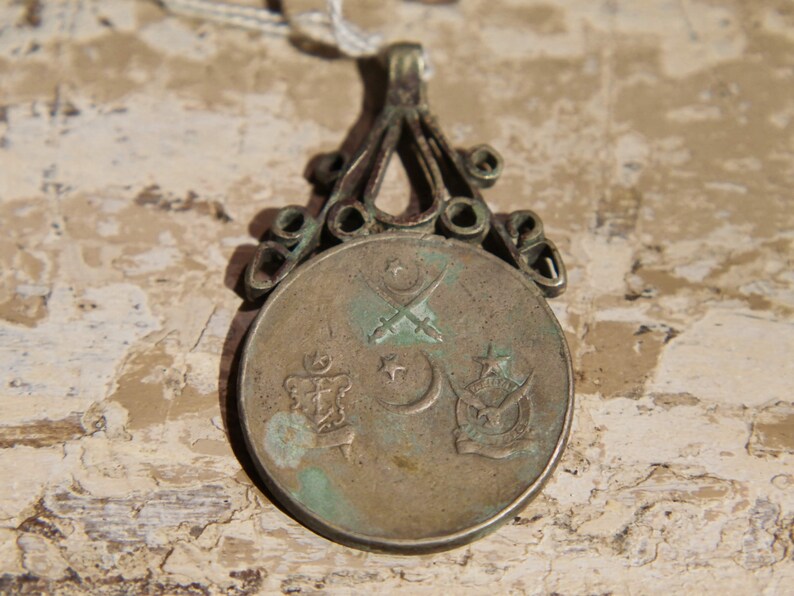 antique pendage with silver alloy coin