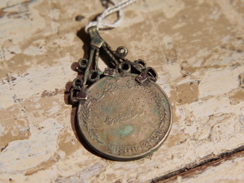 antique pendage with silver alloy coin