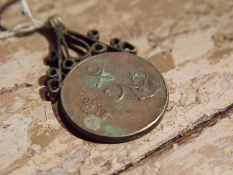 antique pendage with silver alloy coin