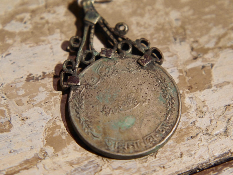 antique pendage with silver alloy coin