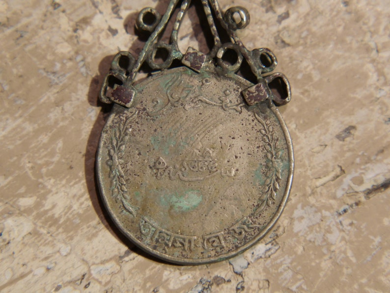 antique pendage with silver alloy coin