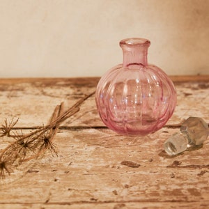 small glass bottle with colored cap code BVR