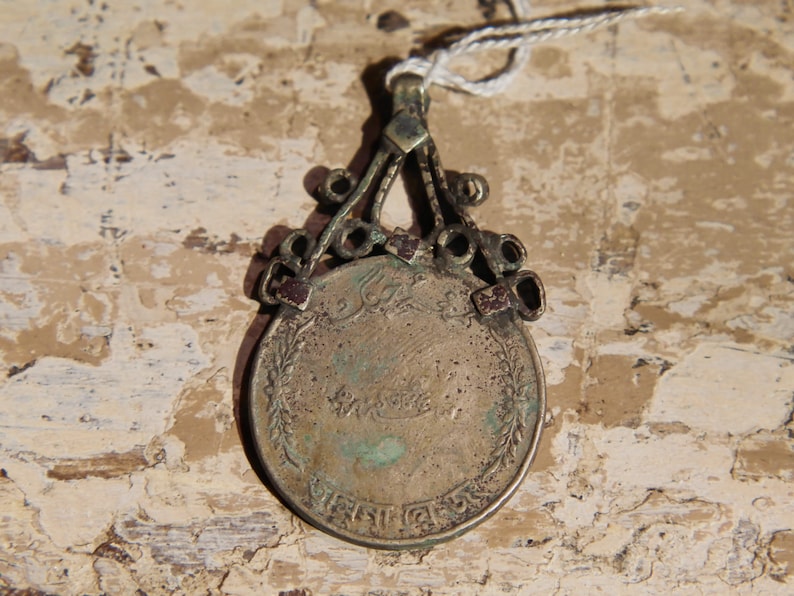 antique pendage with silver alloy coin